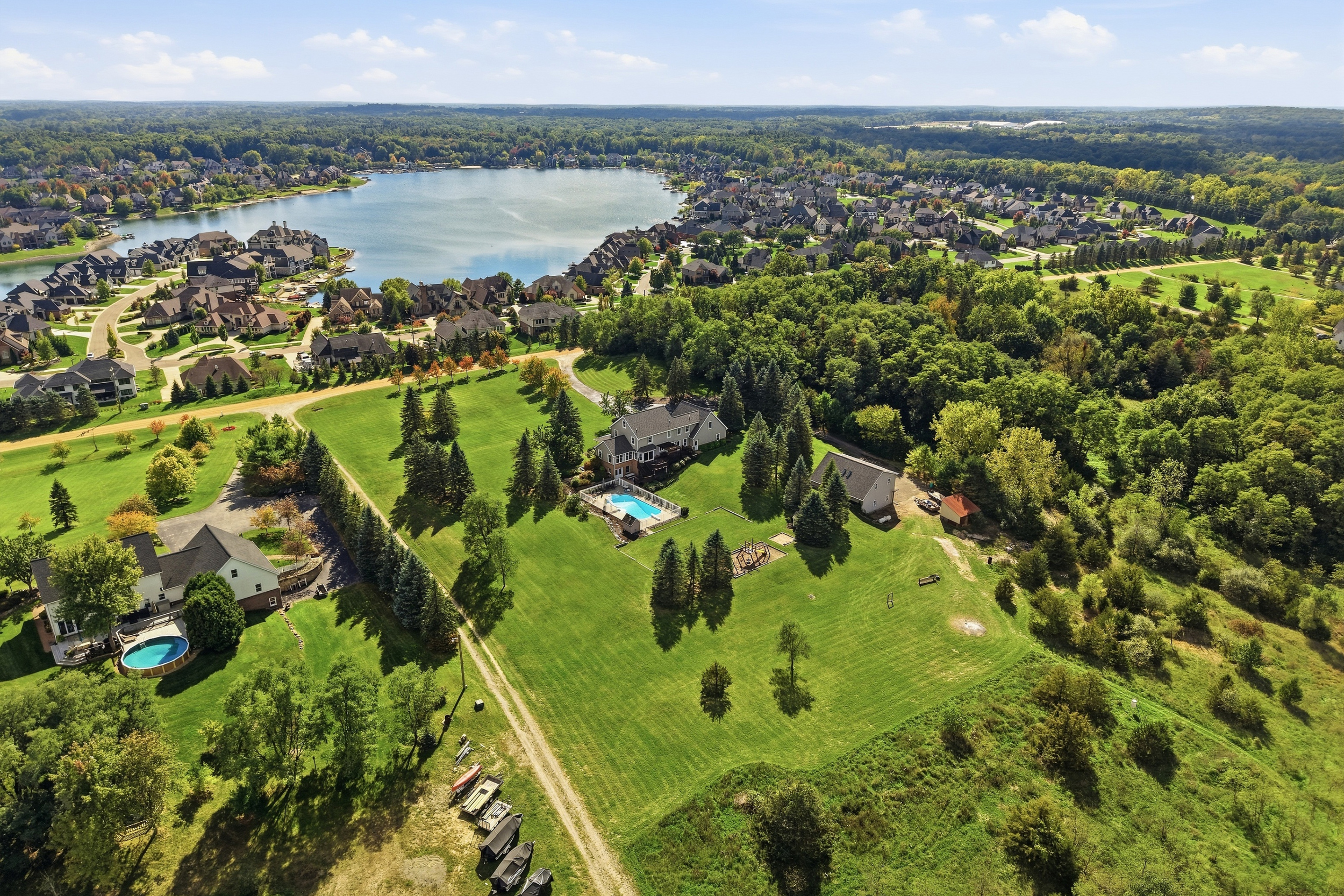 Aerial: pool and lake community